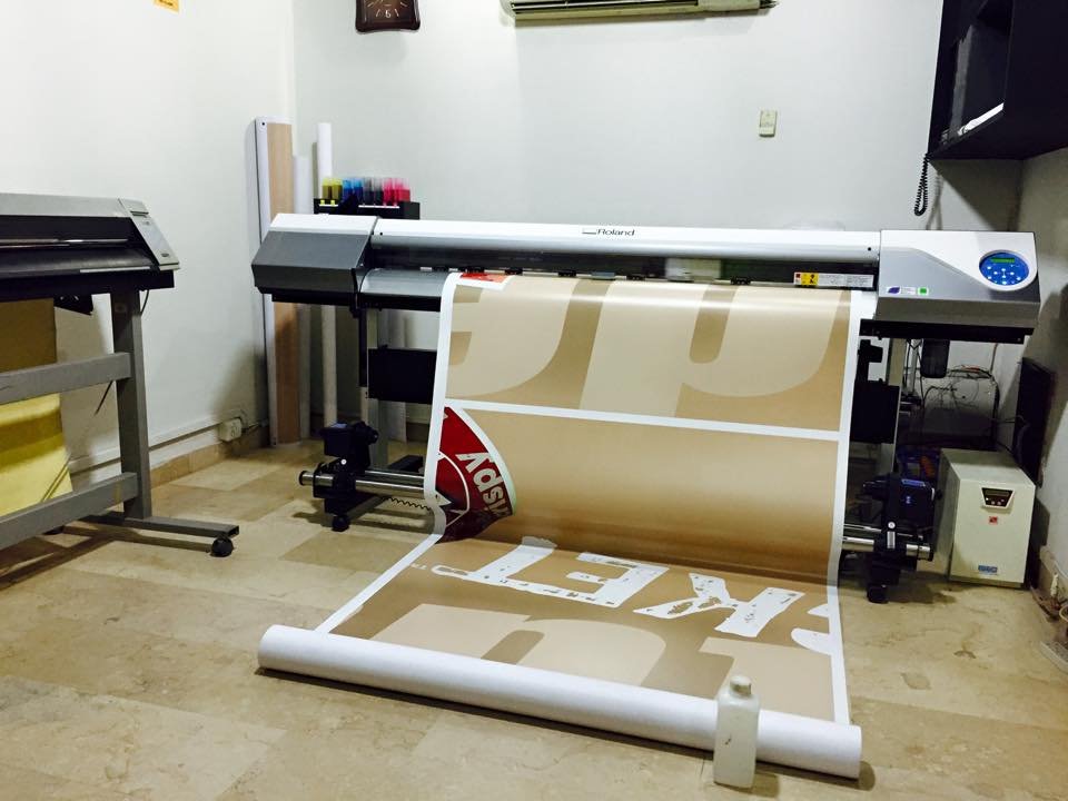 Large-format printer producing a branded print in the studio